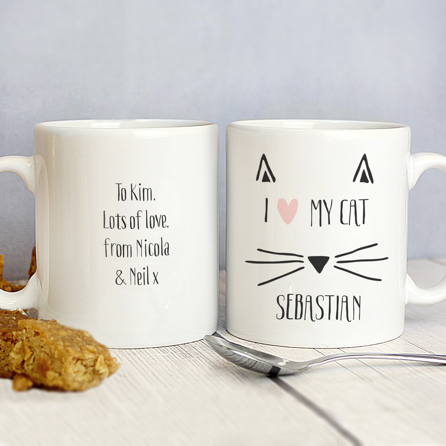 Front and rear image of a white ceramic mug with a fun cat illustration which can be personalised with a name and message of your choice