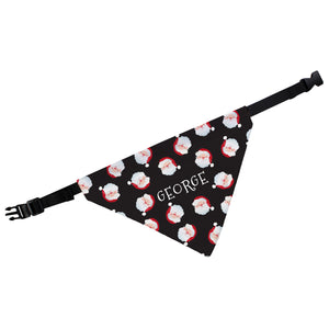 Image of a personalised dog bandana. The bandana has a black background and has lots of smaller smiling Santa faces printed on it. The middle of the bandana has space for a name of your choice to be printed in white upper case letters. The bandana has a black strap which measures up to 43 cm long so it is suitable for small and medium sized dogs.