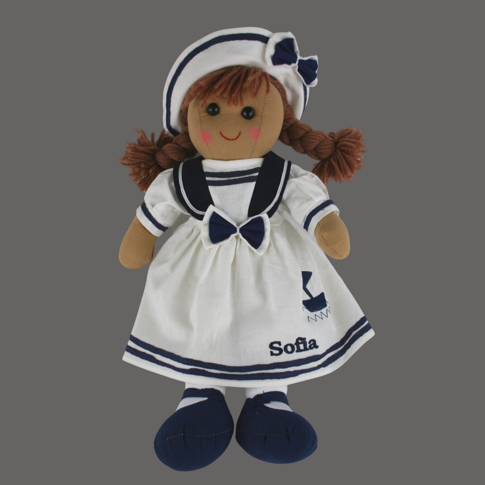 Personalised rag doll in a white dress with blue trim and a white and blue hat. The dress can be personalised with a name of your choice. Suitable for all ages of children.