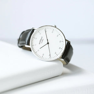 Image of a men's Architect Zephyr watch with a white face and black leather strap. The back of the watch can be engraved with your own handwritten message or drawing.