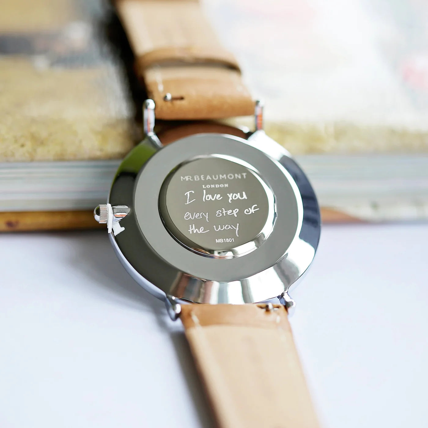 Image of a Mr Beaumont watch with a camel colour Nappa leather strap and a black face. The back of the watch can be engraved with your own handwritten message or drawing.