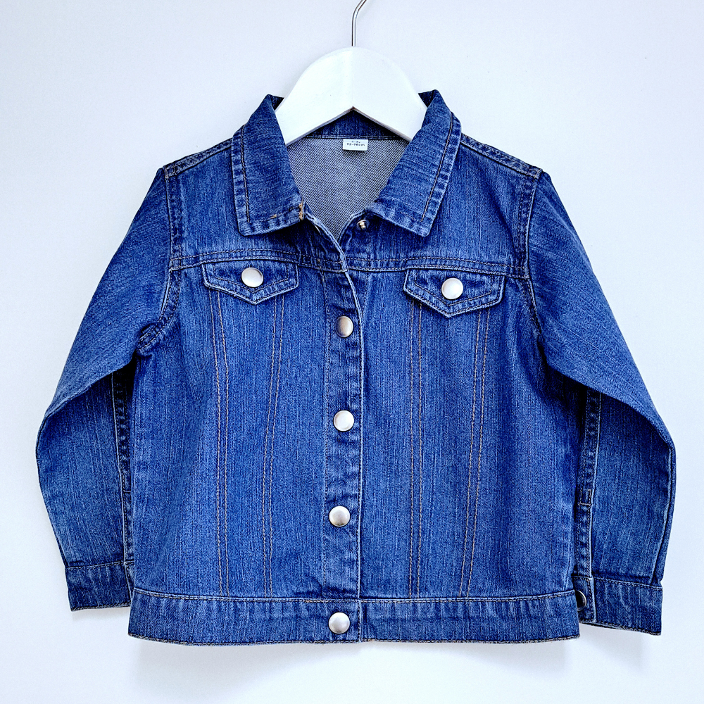 image of the front of a childs denim jacket. The rear of the denim jacket can be personalised with an embroidered applique initial using Liberty of London fabric. Below the initial a name can be embroidered in a thread in a colour of your choice..
