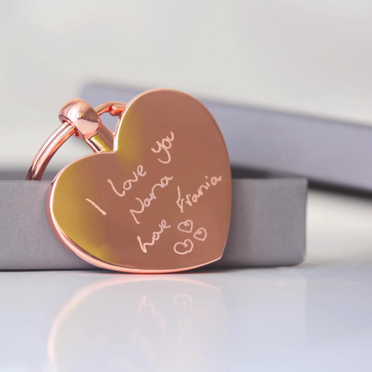 Image of a heart pendant keyring that can be engraved with your own handwriting and/or drawing. A keyring is attached to the pendant which enables you to attach it to keys or a bag.