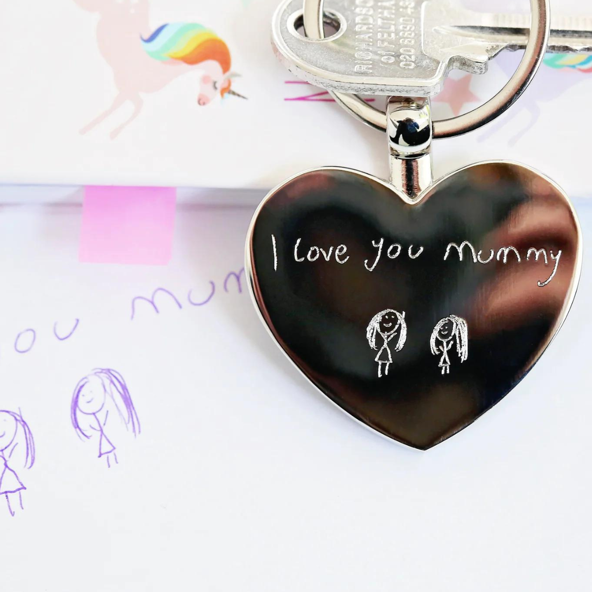 Image of a heart pendant keyring that can be engraved with your own handwriting and/or drawing.  A keyring is attached to the pendant which enables you to attach it to keys or a bag.