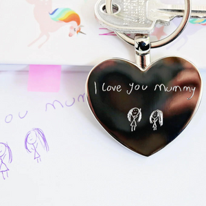 Image of a heart pendant keyring that can be engraved with your own handwriting and/or drawing.  A keyring is attached to the pendant which enables you to attach it to keys or a bag.