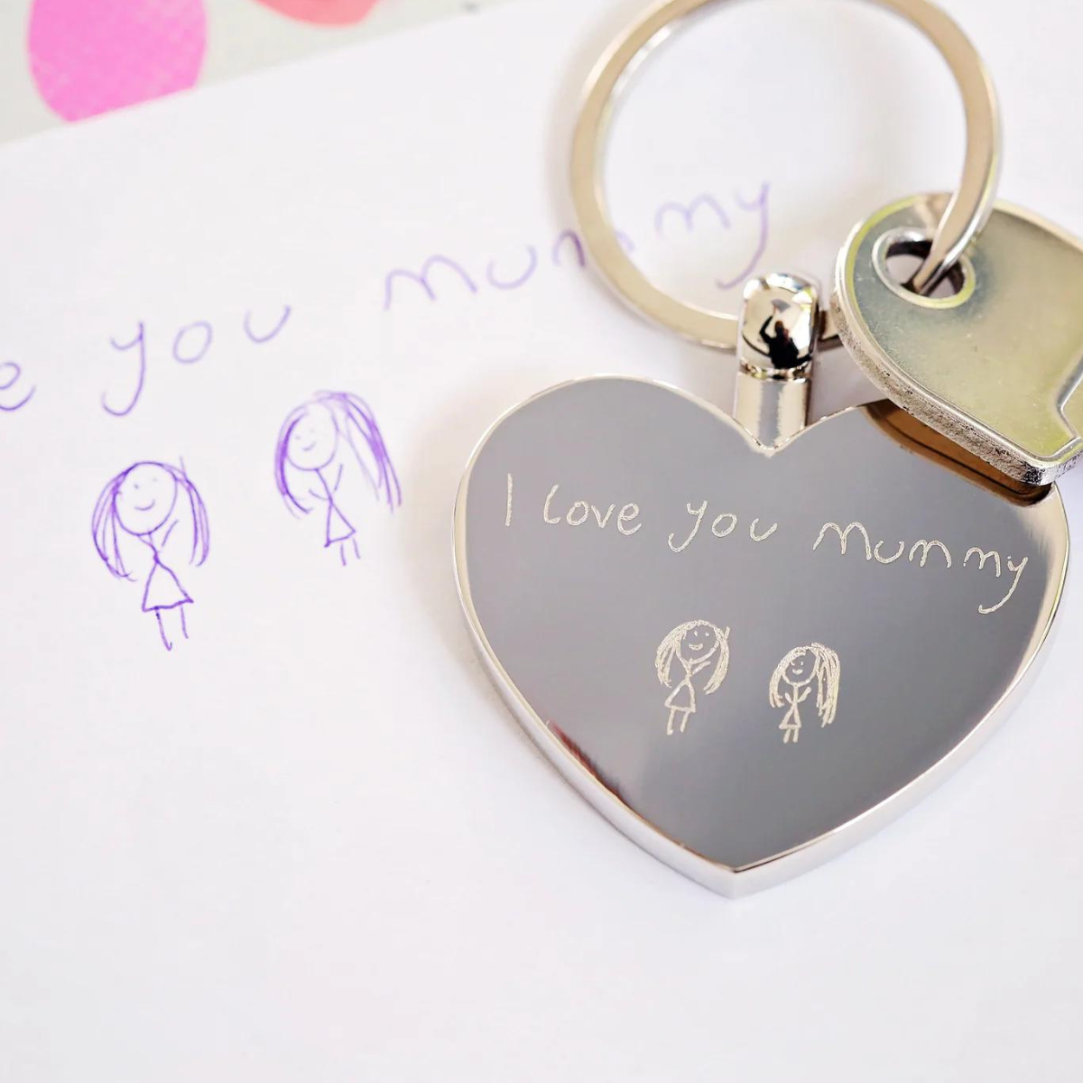 Image of a heart pendant keyring that can be engraved with your own handwriting and/or drawing. A keyring is attached to the pendant which enables you to attach it to keys or a bag.