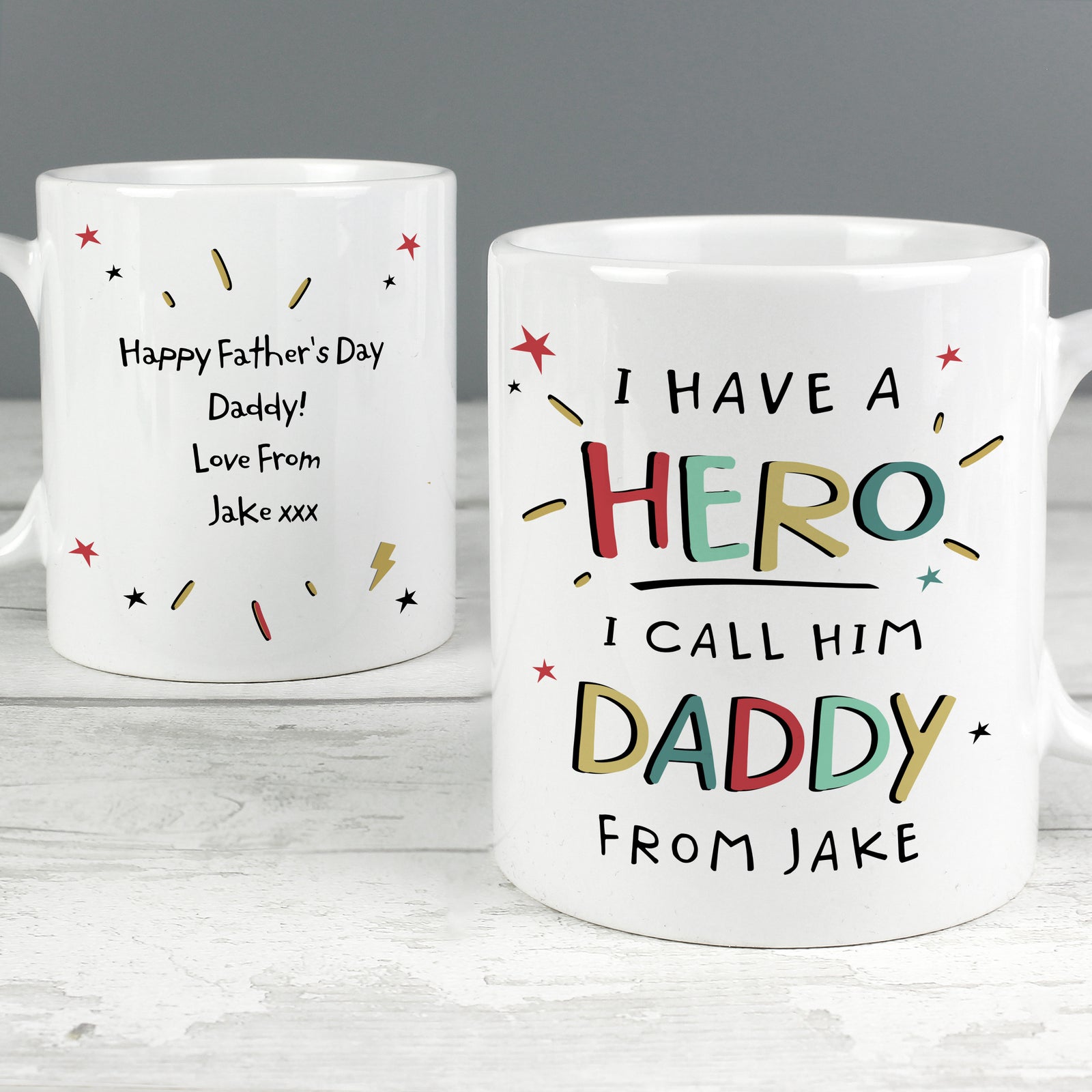 Image of a personalised white ceramic mug for a dad. The front of the mug has 'I have a hero, I call him daddy' on the front that is printed in a large bright uppercase font. Below this there is space to add one line of your own text and the back of the mug can be personalised with your own special message over up to 4 lines which will be printed in a black font.