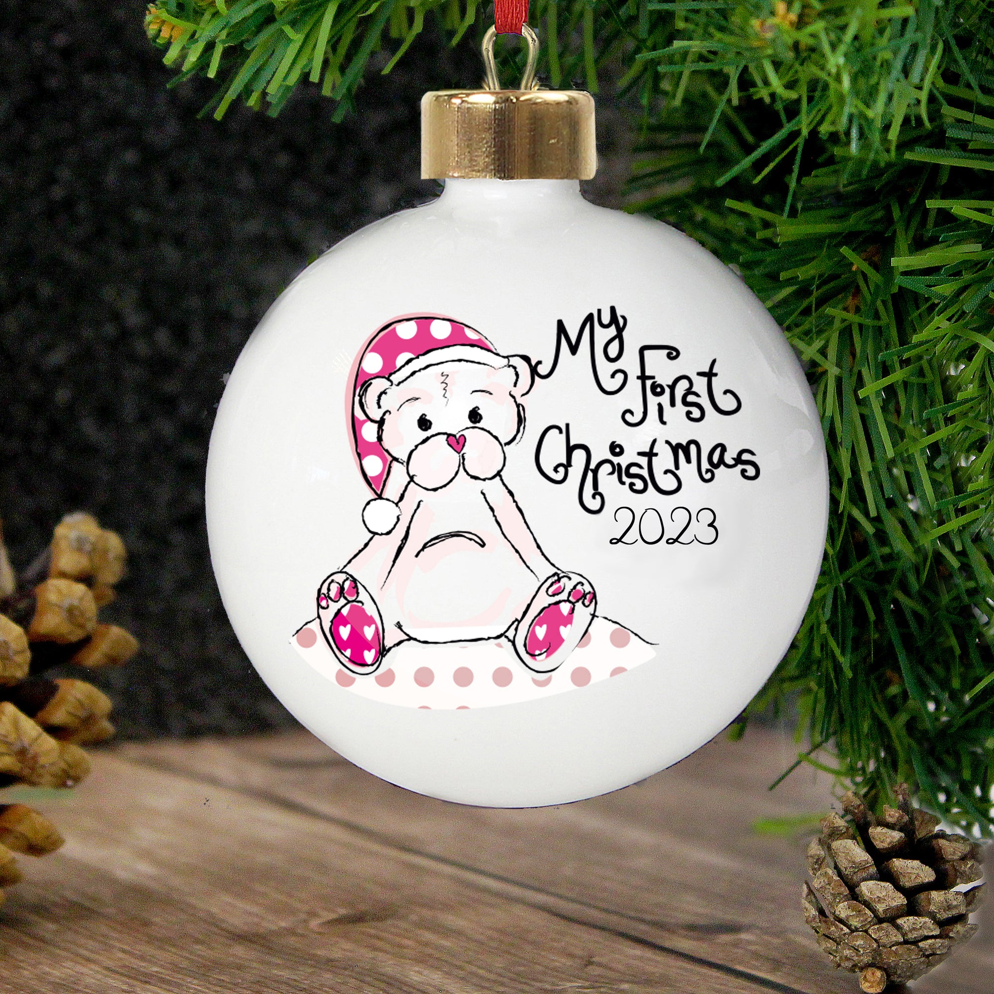 Personalised 'My First Christmas' bauble featuring an image of a hand-drawn bear wearing a Christmas hat on the front of the bauble with the wording 'My First Christmas'. You can also add a year of your choice to the front of the bauble and the rear can be personalised with a message of your choice over up to 4 lines.