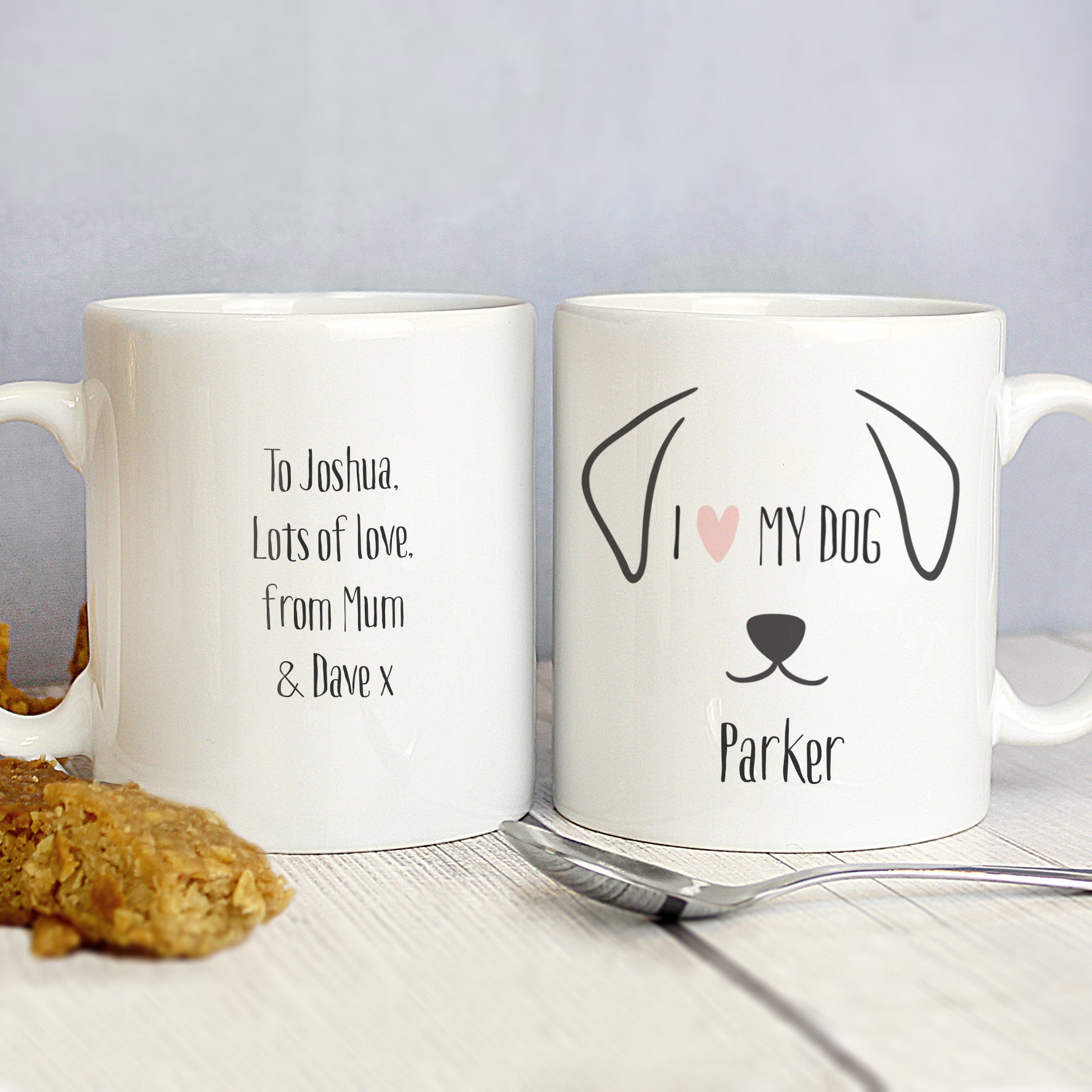 Front and back image of a white ceramic mug with a fun dog illustration that can be personalised with a dog's name and a message of your choice