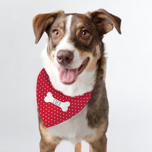 Image of a dog wearing a red polka dot bandana which can be personalised with a name
