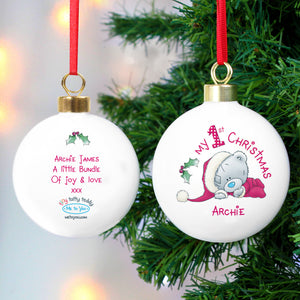 Personalised My 1st Christmas White Ceramic Christmas Bauble featuring an image of a hand drawn Me to You teddy bear. The front of the bauble can be personalised with a name and the back of the bauble with your own message over 4 lines.