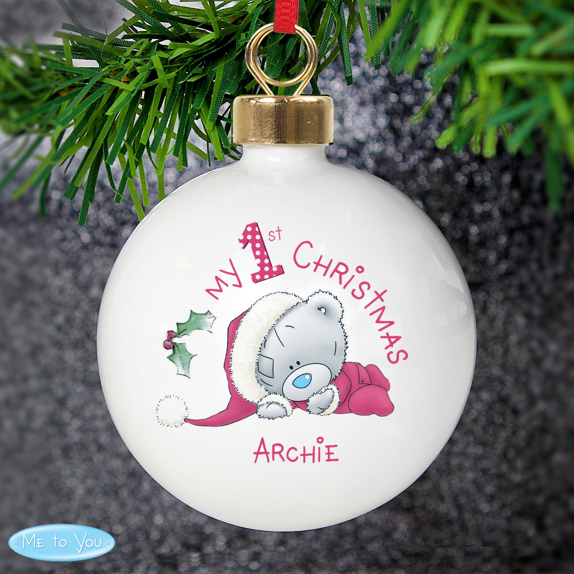 Personalised My 1st Christmas White Ceramic Christmas Bauble featuring an image of a hand drawn Me to You teddy bear. The front of the bauble can be personalised with a name and the back of the bauble with your own message over 4 lines.