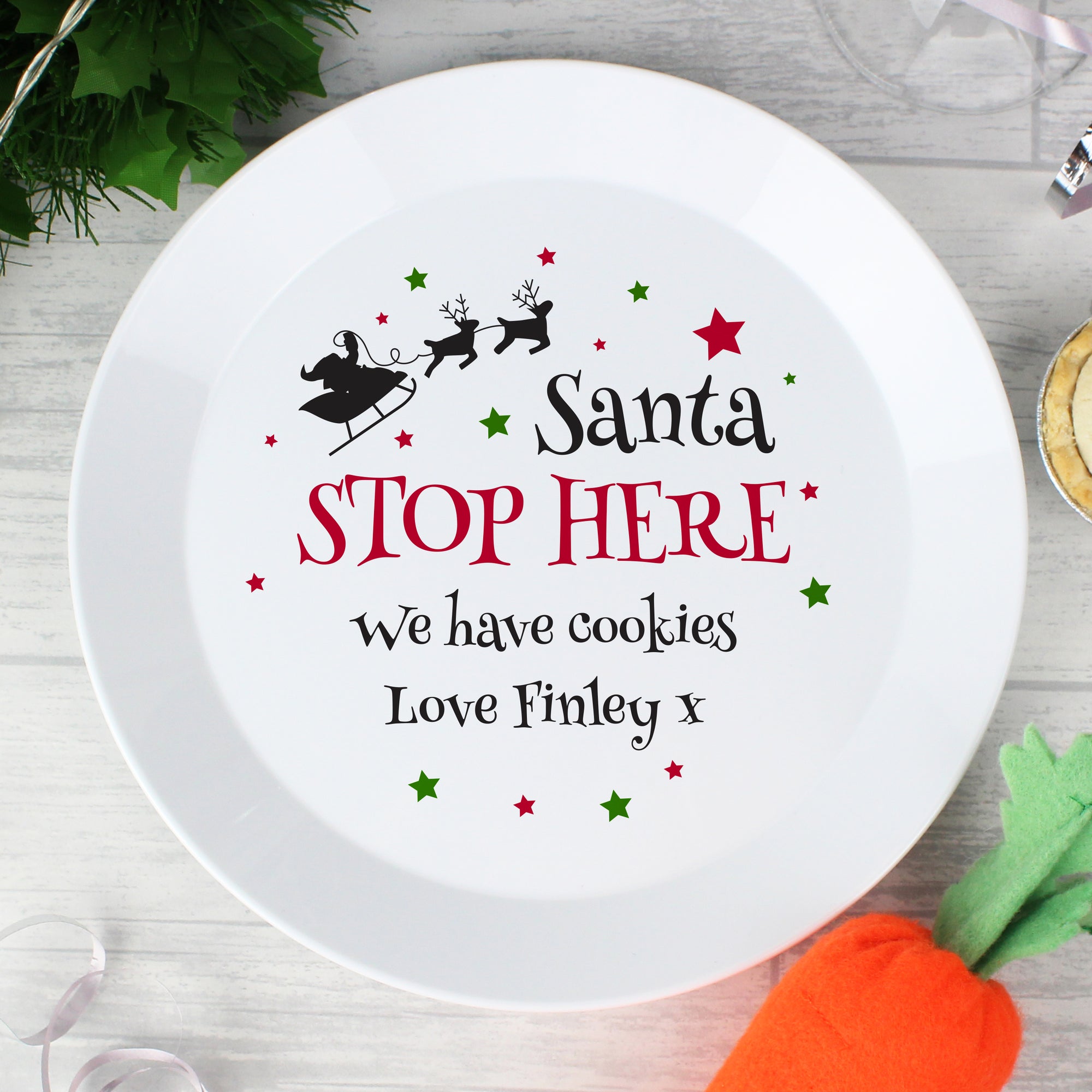 Personalised Christmas Eve Plate featuring the wording 'Santa STOP HERE' in black and red which can then be personalised with your own message over 2 lines of up to 20 characters per line. Made from white shatter-proof BPA free plastic.