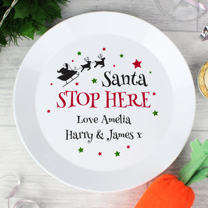 Personalised Christmas Eve Plate featuring the wording 'Santa STOP HERE' in black and red which can then be personalised with your own message over 2 lines of up to 20 characters per line. Made from white shatter-proof BPA free plastic.