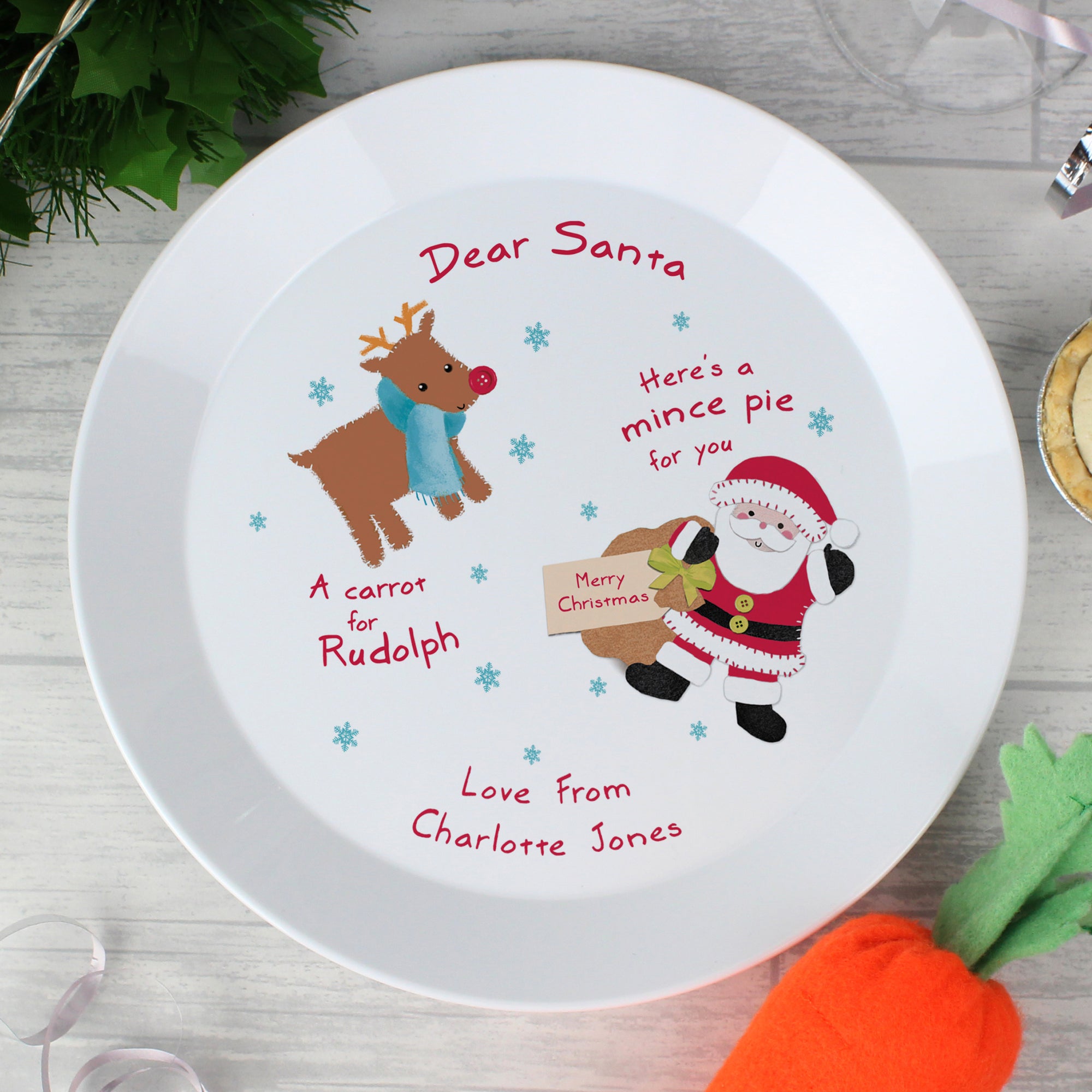 Personalised Christmas Eve Plate for Santa & Rudolph with an image of Santa carrying a sack and Rudolph wearing a blue scarf which can be personalised with two lines of your own text