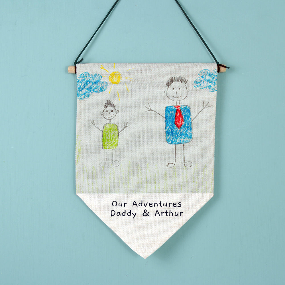 Image of a linen hanging banner that can be printed with your child's own artwork. There is also space under the artwork to add your own text over 2 lines which will be printed in a black handwritten style font.