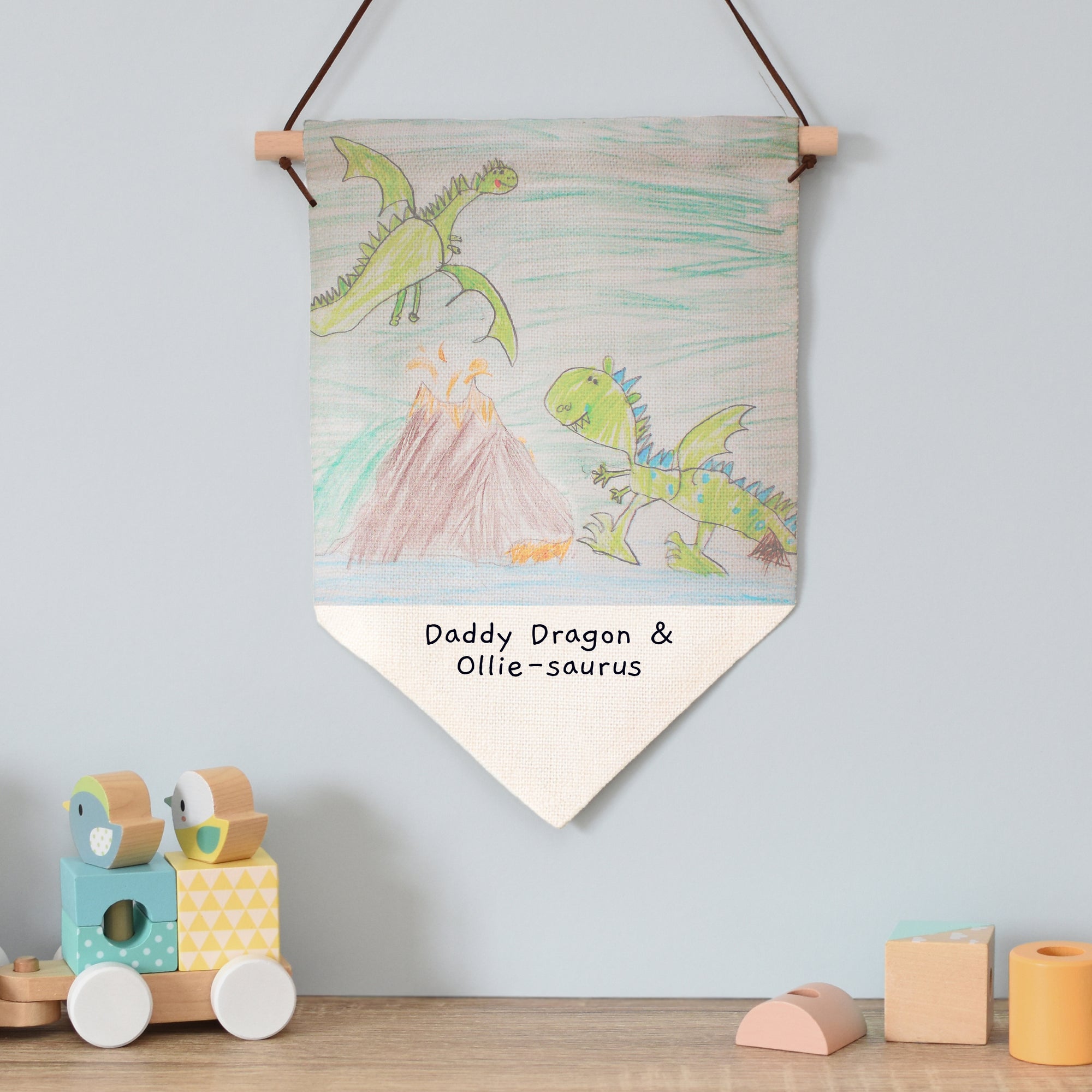 Image of a linen hanging banner that can be printed with your child's own artwork. There is also space under the artwork to add your own text over 2 lines which will be printed in a black handwritten style font.