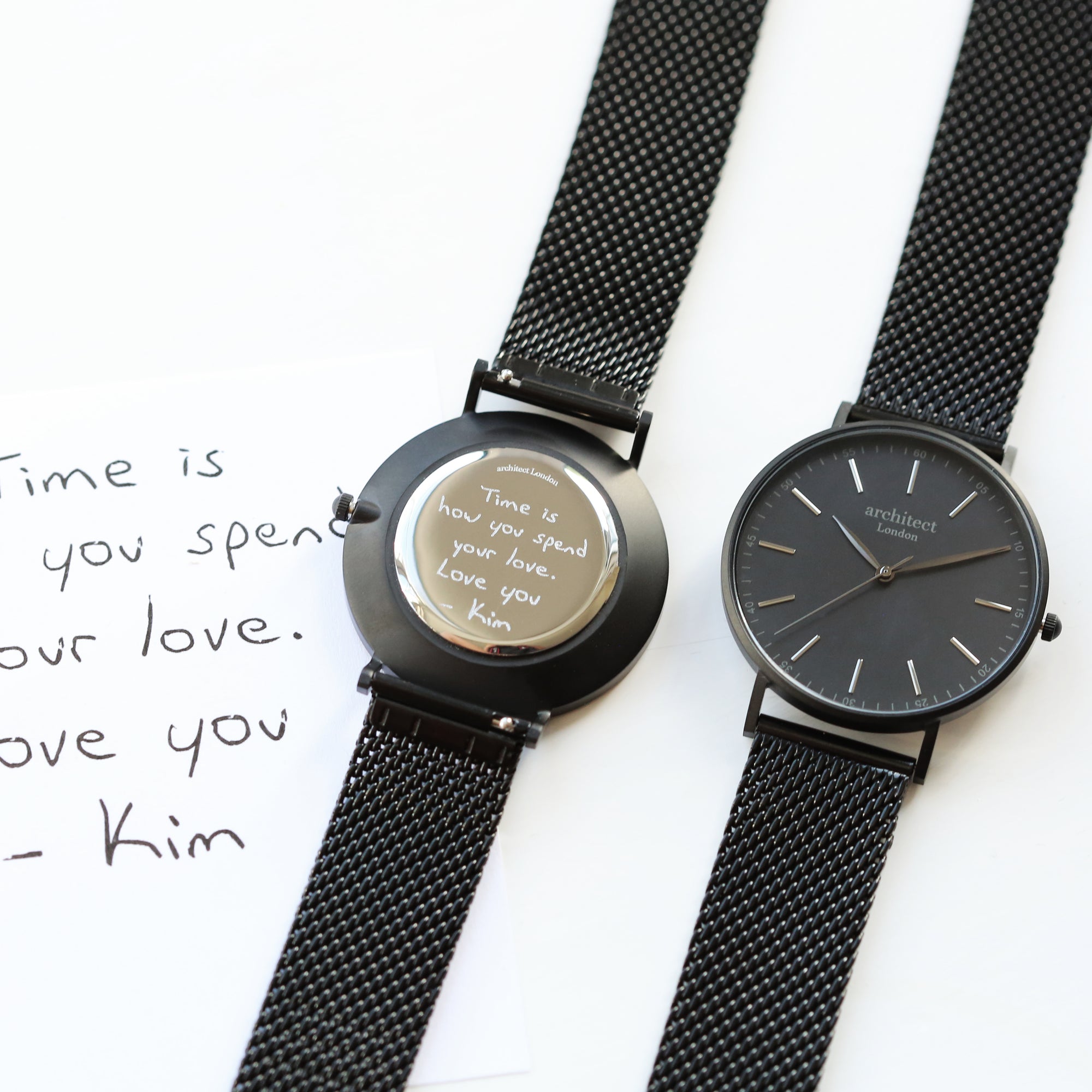 Front and rear image of a men's watch that can be engraved on the back with your own handwriting. The watch is made by Architect London and has a large black face and a black stainless steel mesh strap. The rear of the watch can be engraved with your message written in your own handwriting.