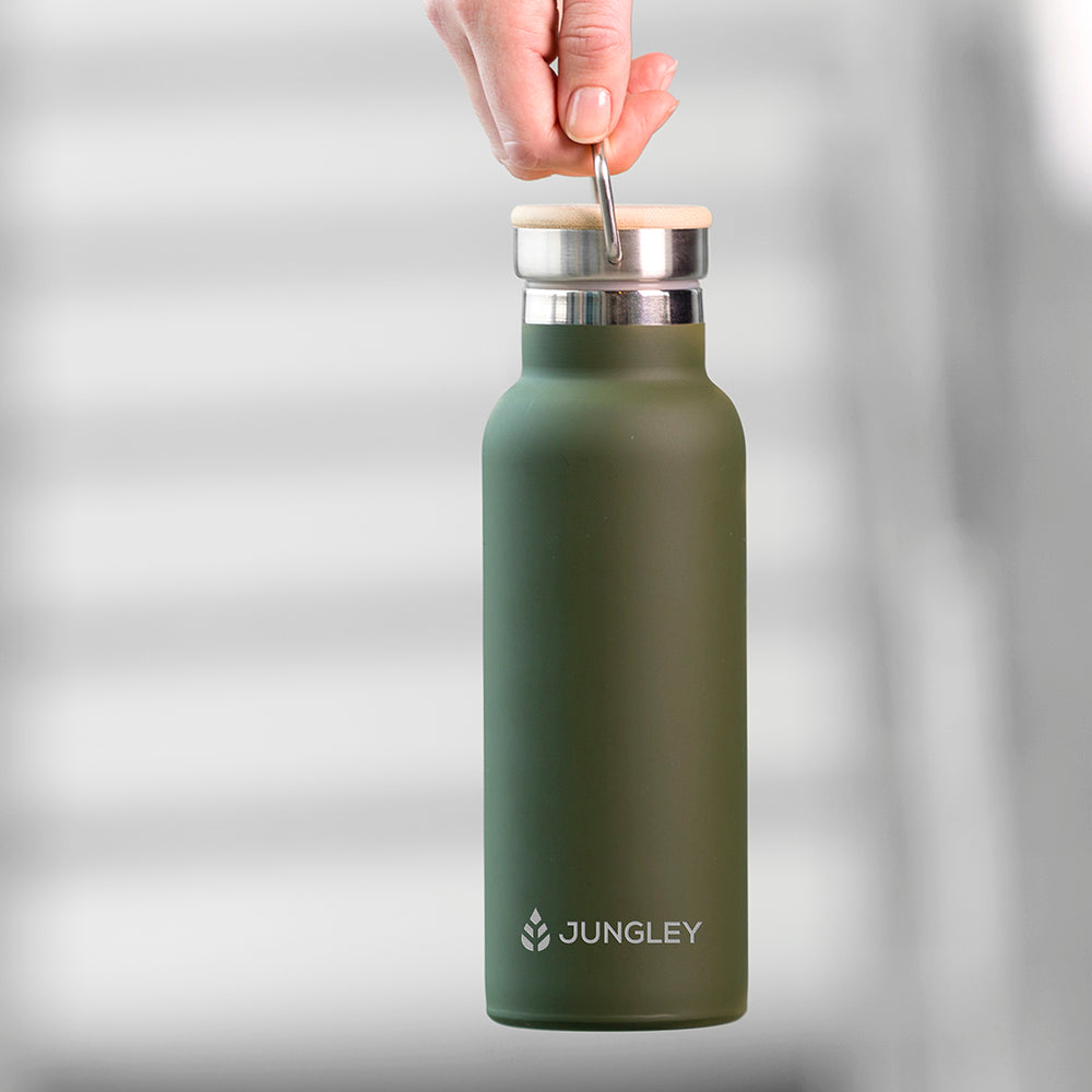 Personalised matt green insulated drinks bottle with a double wall and a bamboo vacuum screw top lid. The side of the bottle can be engraved with a name of your choice in uppercase.