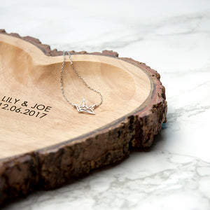Image of a hand-carved heart-shaped wooden bowl that has a rustic natural bark edging. The bowl can be personalised with your own message which will be engraved in an upper case font.