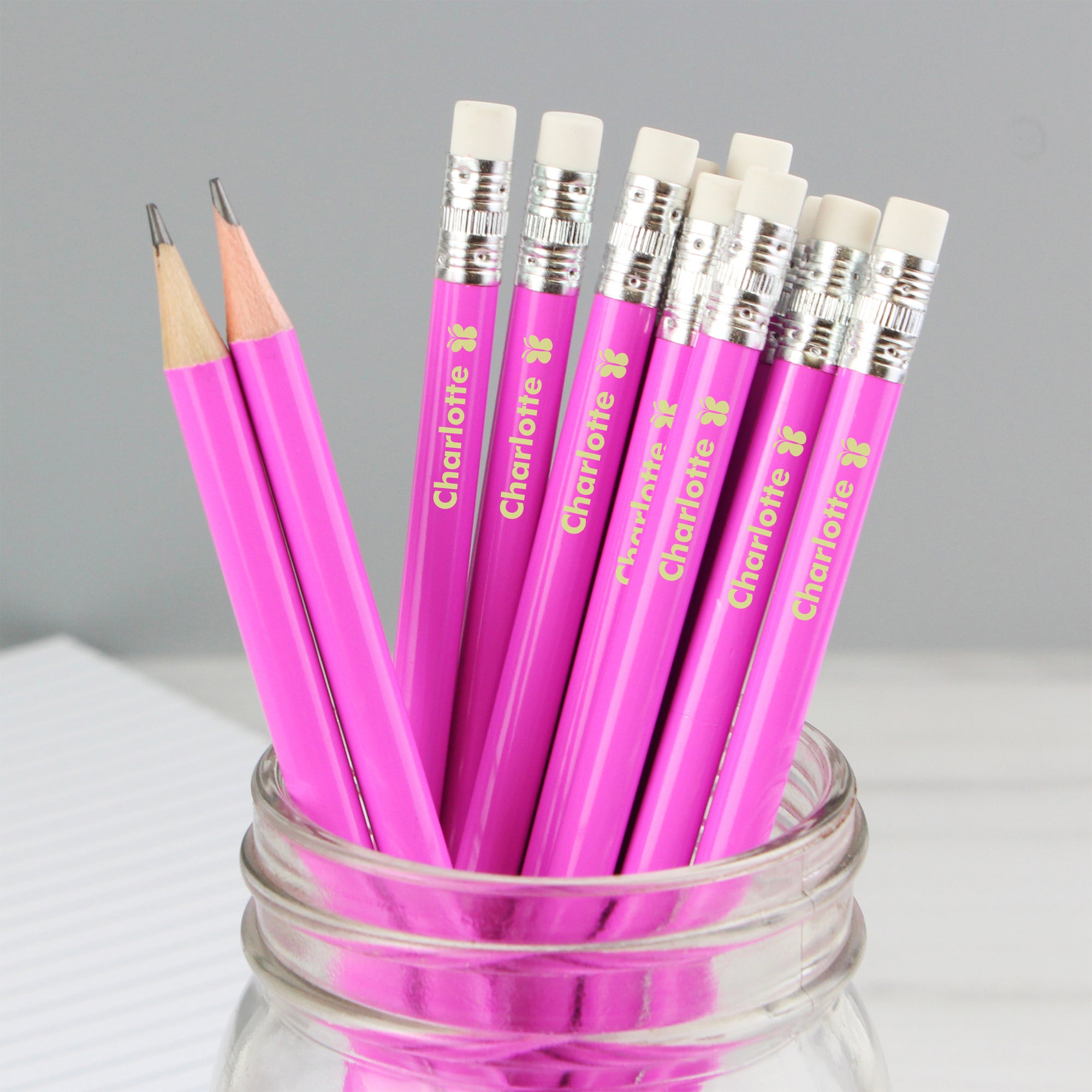 Set of 12 personalised HB pink pencils topped with an eraser and with a small butterfly motif after the name.