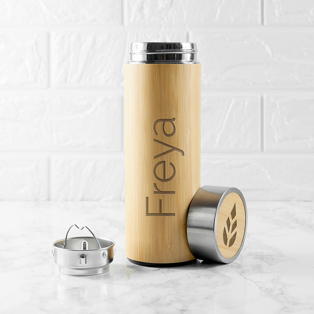 Personalised bamboo vacuum flask with a screw top lid and an optional stainless steel tea strainer insert. The flask is stainless steel double walled insulated and the outside is made from natural bamboo which can be engraved with a name of your choice. 