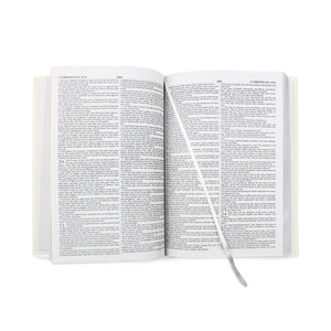 Image of the internal pages of a personalised bible with a white leatherette cover which can be personalised with up to 5 lines of text below a cross. The printing can be done in silver or gold. The bible has a ribbon bookmark,
