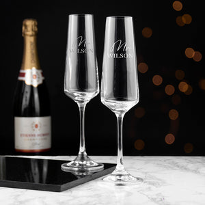 Image of a pair of champagne flutes that can be personalised as Mr/Mr, Mrs/Mrs or Mr/Mrs which will be engraved in a cursive font then a surname of up to 12 characters which will be engraved in an uppercase font.