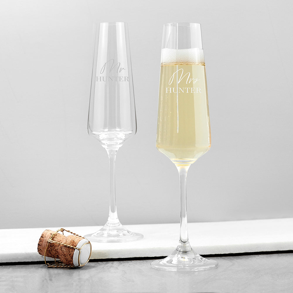 Image of a pair of champagne flutes that can be personalised as Mr/Mr, Mrs/Mrs or Mr/Mrs which will be engraved in a cursive font then a surname of up to 12 characters which will be engraved in an uppercase font.