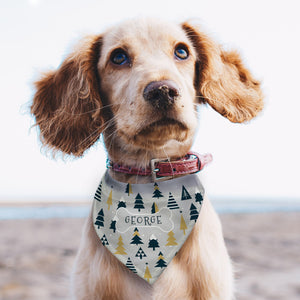 Image of a spaniel dog wearing a personalised bandana for dogs. The bandana features a modern Christmas tree design and has a maximum strap length of 43cm making it suitable for small and medium sized dogs. The bandana features a printed bone in the centre of the bandana and it can be personalised inside the bone with a name of your choice of up to 12 characters which will be printed in upper case text.
