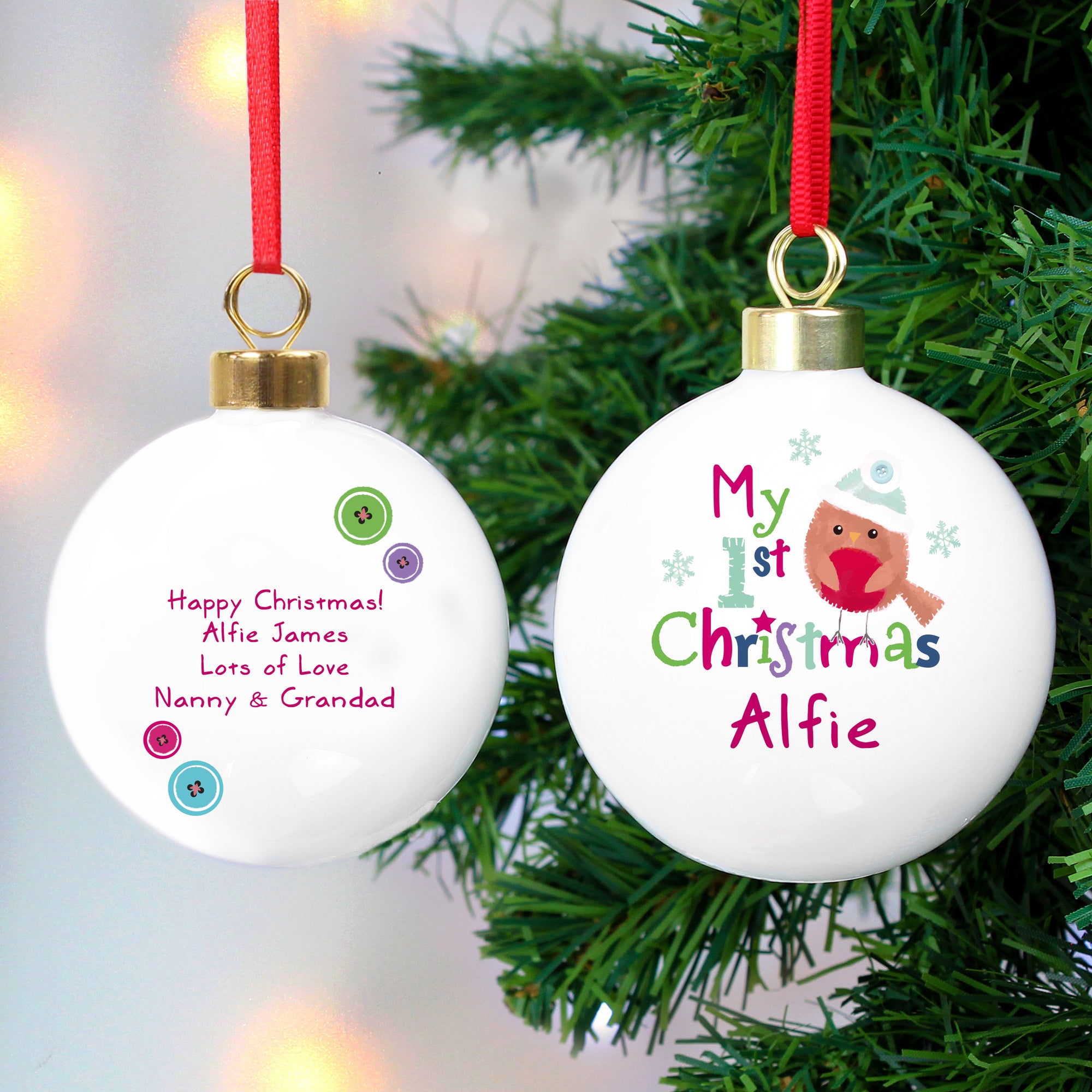 Personalised white ceramic 'My 1st Christmas' Christmas tree bauble featuring an image of a hand-drawn robin. The front of the bauble can be personalised with a name of your choice and the rear of the bauble can be personalised with a message of your choice over up to 4 lines of text.