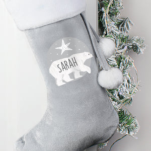 Personalised grey velvet Christmas stocking with a plush white trim. The front of the stocking features an illustration of a hand-drawn polar bear with a star above it and the stocking can be personalised with a name of your choice which will be printed in a black modern uppercase font inside the image of the bear.