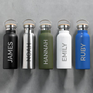 Personalised insulated drinks bottles in matt black, stainless steel, matt green, matt white and matt blue. Each bottle has a leak proof bamboo vacuum sealed lid and a carry handle. The bottles can be personalised in a name of your choice which will be printed down the side of the bottle in large uppercase letters.