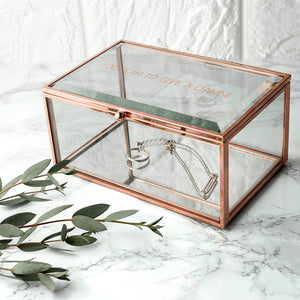 Image of a jewellery box made from rose gold coloured metal and glass with a mirrored bottom. The jewellery box can be personalised with a message of your choice of up to 50 characters in rose gold filled letters in uppercase on the glass lid of the box.