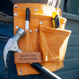 Image of a tool belt made from heavy duty tan leather. The belt has 11 pockets for carrying essential tools, nails, screws, pens, scissors, tape measure, etc necessary for DIY, construction, florists or artists. The belt has a fully adjustable nylon webbed belt to fit around an adult waist. The tool belt has a leather tag which can be personalised with a message of your choice.