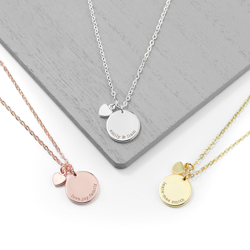 Image of 3 personalised necklaces, one is 18ct rose gold plated, one is sterling silver plated and the other is 18ct gold plated.  All of the necklaces have a polished disc that can be engraved with your own message or names of your choice of up to 25 characters. There is also a small polished heart on the necklace chain which sits just above the engraved disc.