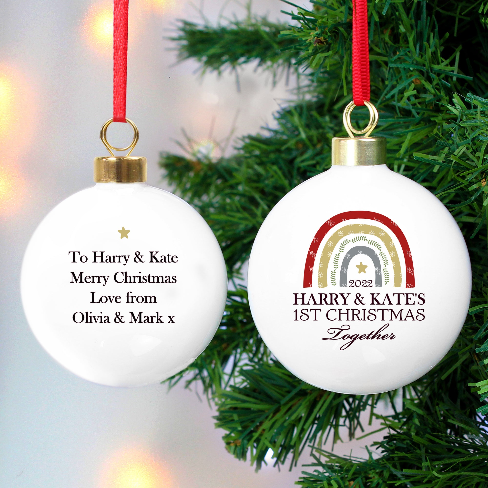 Personalised Christmas bauble. The front of the bauble features a rustic looking rainbow over a gold star. The front of the bauble can be personalised with a year (optional) and your own text over 3 lines. The rear of the bauble can be personalised with your own special message over up to 4 lines. The bauble is made from white ceramic and measures approximately 6 cm across.