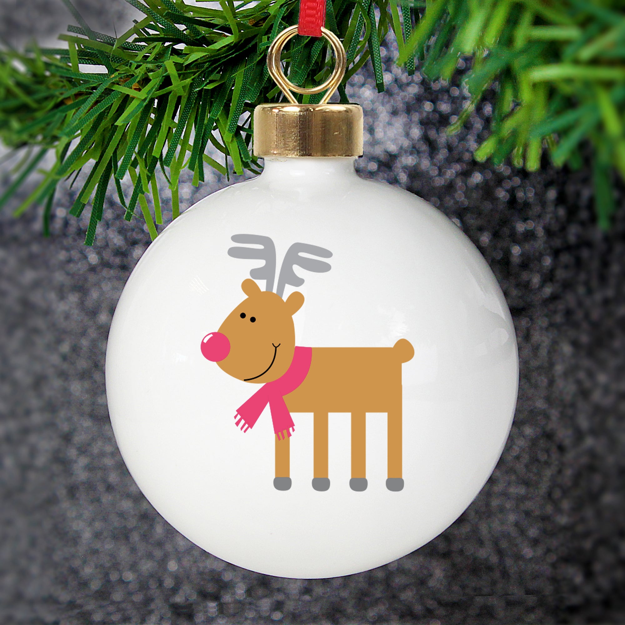 Personalised round Christmas tree bauble featuring a cartoon drawing of Rudolph the Red Nose Reindeer on the front.  Made from white glazed ceramic, the rear of the bauble can be personalised with your own message over 4 lines.