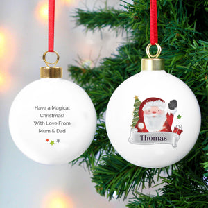 Image of the front and back of a personalised Christmas bauble. The bauble is white, the front features an image of a happy Santa waving and below him is a grey banner which will have a name of your choice printed in it in black font. You can add your own message to the back of the bauble which will be printed in a black font with three stars underneath the writing.