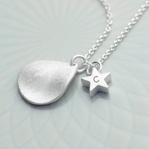 Personalised necklace plated in sterling silver. The necklace has a matt finish drop shape on it and a small matt finish star which can be engraved with an initial.