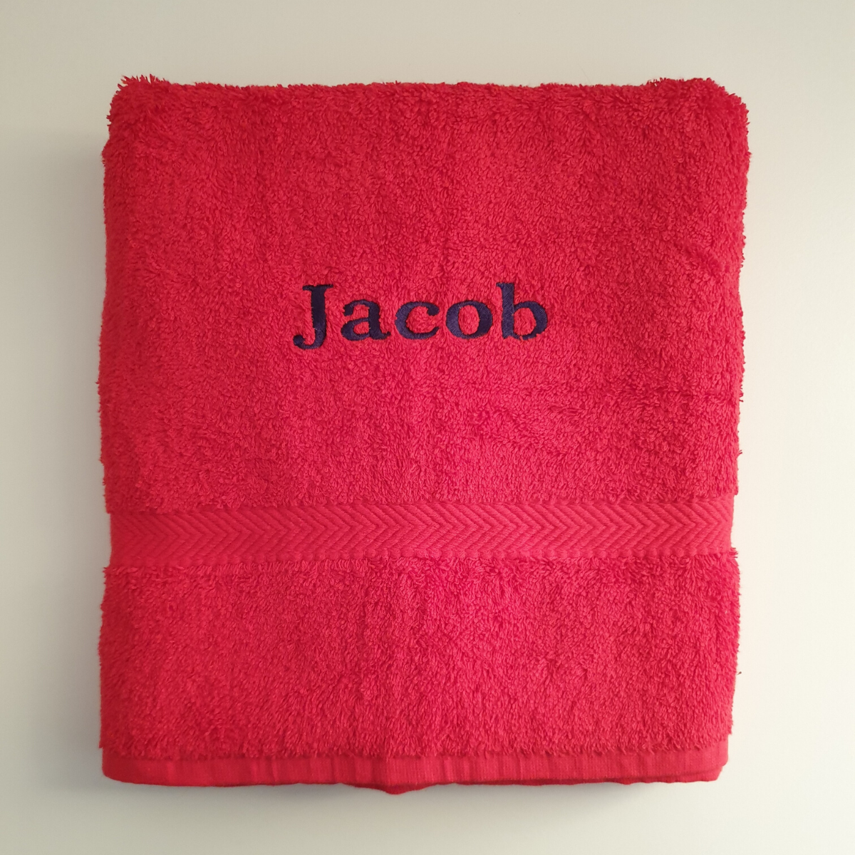 Personalised towel for holidays, swimming lessons, sports, camping trips and more. Made from 100% super soft cotton which is super absorbant, the towel measures approximately 70 cm by 130 cm. The towels are available in ed,r navy, white, slate, fuchsia, pale pink and purple with a wide range of colour options for the name.