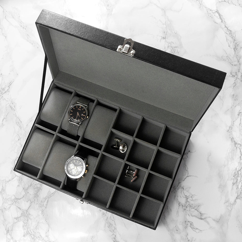 Image of a black box with 12 internal compartments for holding cufflinks and storage for up to 6 watches. The box is made from black PU leather and fastens shut with a silver coloured clasp. The lid of the box has a silver coloured plaque that can be engraved with your own text over 2 lines of up to 10 characters per line in your choice of two fonts.