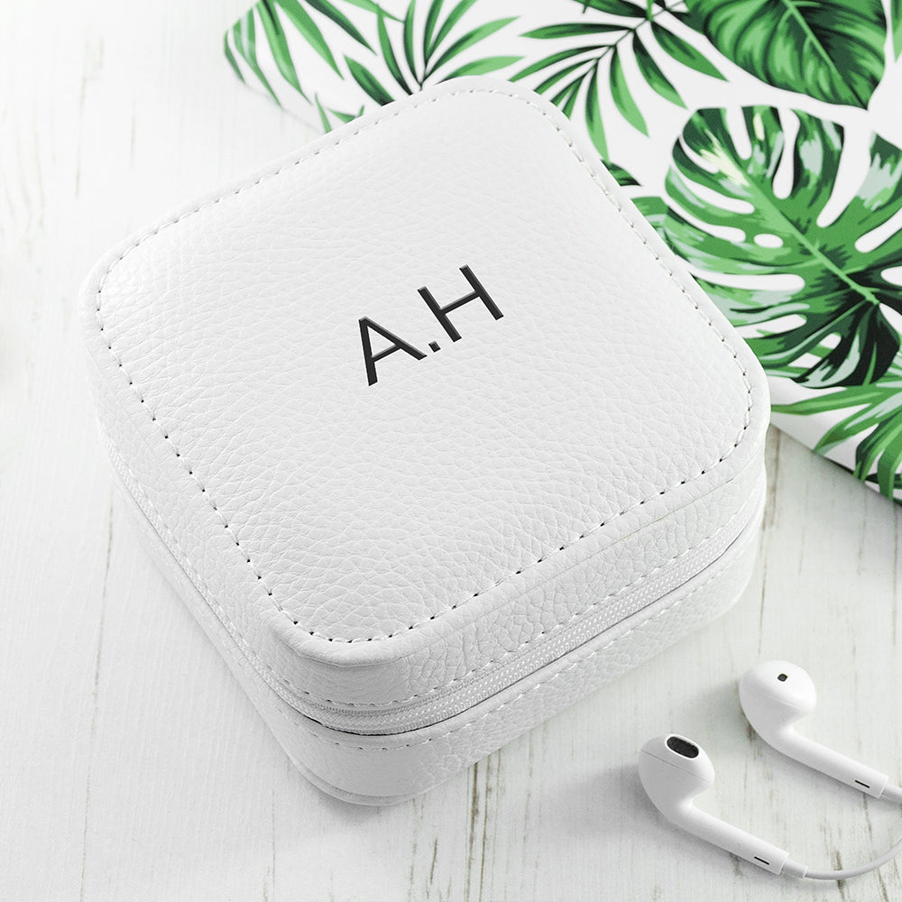 Image of a white leather square travel jewellery case that can be personalised with a name of your choice of up to 15 characters on the lid in a choice of colours and 3 different fonts. The case closes securely with a white zip and internally has flock lined compartments for storing jewellery.